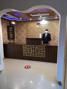 a man is standing at a counter in a room at The Nest Resort in Eldoret