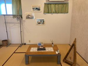 a room with a table in the middle of a room at Oyado Sukeya in Saijo