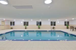 a large swimming pool with blue water in a building at Wingate by Wyndham Fort Saskatchewan in Fort Saskatchewan