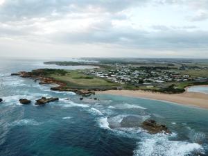 an aerial view of the ocean and a beach at Peterborough House in Peterborough