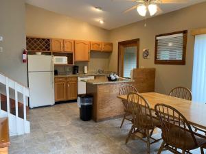 a kitchen with a table and a white refrigerator at Pocono Villas Resort in East Stroudsburg