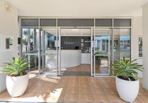 a kitchen with a white refrigerator and a large window at Elouera Tower in Maroochydore