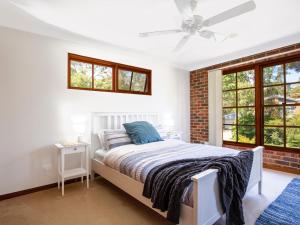 Callala BayEagles Point I Water Views I Pet Friendly的一间带床和砖墙的卧室