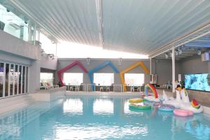 a large swimming pool with inflatables in a building at Pacific Regency Hotel Suites in Kuala Lumpur