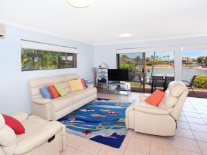 a living room with two couches and a television at Courtney Cove 1 Comfortable Two Bedroom Apartment on Mooloolaba Canal in Mooloolaba