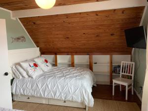 a bedroom with a bed with a wooden ceiling at Salty Poodle Cottage in Freeport