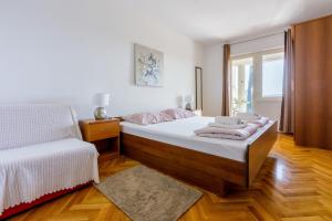 Postel nebo postele na pokoji v ubytování Apartments ALEX