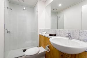 a bathroom with a sink, toilet and bathtub at Quest Southbank in Melbourne
