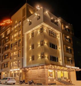 a building with a car parked in front of it at Treebo Trend Opulence Inn in Udaipur