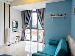 a living room with a blue couch and a large window at Vivo Residential Suites 9 Seputeh by Lovelyhome in Kuala Lumpur