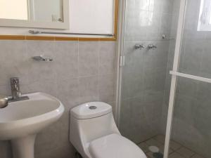 a bathroom with a toilet and a sink and a shower at House with Pool near the Beach CTE69 in Mezcales +6 photos