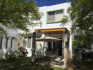 a patio with an umbrella and a table and chairs at House with Pool near the Beach CTE69 in Mezcales