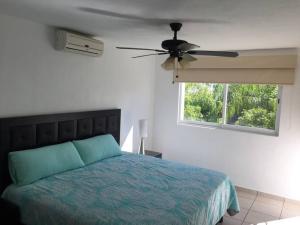a bedroom with a bed and a ceiling fan at House with Pool near the Beach CTE69 in Mezcales