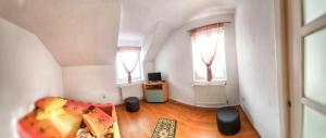 a living room with a couch and two windows at CABANA ZIMBROAIA 8 camere -Muntii Bârgăului, Transilvania in Piatra Fantanele