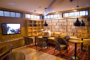 a man sitting on a couch in a library at Finlandia Hotel Isovalkeinen in Kuopio