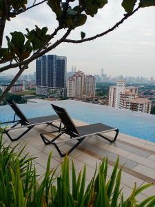 a table and chairs sitting on top of a swimming pool at THE NEST @ GENTING KLANG SETAPAK KUALA LUMPUR in Kuala Lumpur