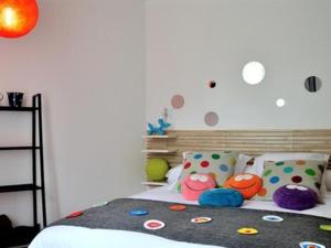 Lodges Lao في Bully: غرفة نوم مع سرير مع وسائد ملونة