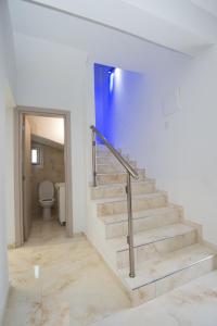 a staircase in a white room with a toilet at Makronissos Beach Villas in Ayia Napa