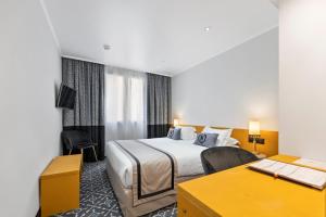a hotel room with a bed and a desk at Napoleon in Ajaccio