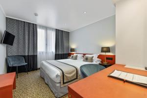a hotel room with a bed and a desk at Napoleon in Ajaccio