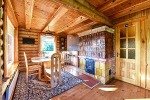 a dining room with a table and a stove at Vila Karališkis in Karališkiai