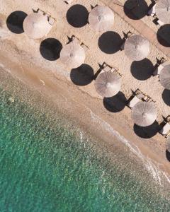 an overhead view of people on the beach with umbrellas at Georgalas Sun Beach Resort in Nea Kallikrateia