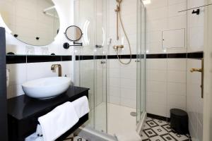 W łazience znajduje się umywalka i przeszklony prysznic. w obiekcie Art Deco WOLKER by ASTORIA Hotel & Medical Spa w Karlowych Warach