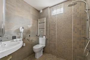 a bathroom with a toilet and a sink and a shower at Napoleon in Ajaccio