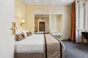a hotel room with a large bed and a window at Napoleon in Ajaccio