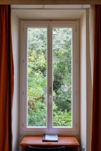 a window in a room with a wooden table at Napoleon in Ajaccio