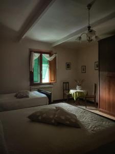 Łóżko lub łóżka w pokoju w obiekcie La Casa dei Nonni