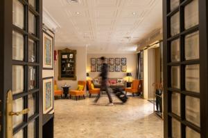 a person walking through a hallway in a living room at Napoleon in Ajaccio