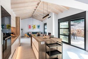 a kitchen with a island in the middle of a room at Swedish-Style Villa Salz in Fiskardho