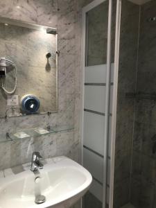 a bathroom with a sink and a shower at Grand Hôtel De Paris in Paris