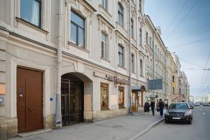 a car parked on a street next to a building at Station Hotel G73 in Saint Petersburg