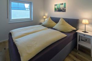 Ein Bett oder Betten in einem Zimmer der Unterkunft Südwester