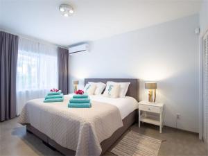 a bedroom with a bed with two pillows on it at Palms & Pools apartment at Curacao Ocean Resort in Willemstad +83 photos