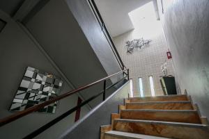 a hallway with stairs in a building with graffiti on the wall at Hôtel Spunta Di Mare in Ajaccio