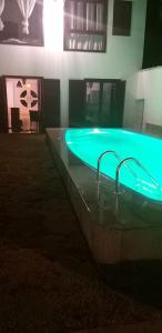a hot tub with blue lights in a room at Casa praia do espelho, Outeiro das Brisas in Praia do Espelho