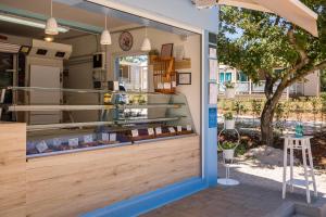 a store front with a glass door with a tree in the background at Mobile Homes - Lanterna Premium Camping Resort in Poreč