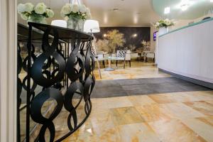 a lobby with a table with flowers on it at Hôtel Spunta Di Mare in Ajaccio