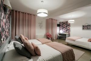 a hotel room with two beds and a desk at Hôtel Spunta Di Mare in Ajaccio