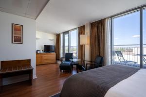 a hotel room with a bed and a balcony at Holiday Inn London Camden Lock by IHG in London