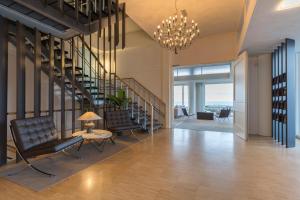 a living room filled with furniture and a stairwell at de Baak Seaside in Noordwijk aan Zee
