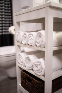 a rack of towels in a bathroom with a toilet at Old Town Apartment in Rottweil