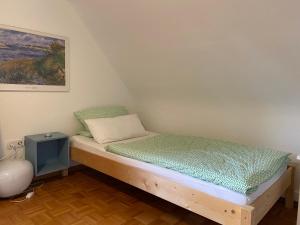 a small bed in a room with a painting at Ferienwohnung Seerose Bad Wildbad i. Schwarzwald in Bad Wildbad