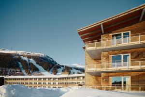 a building in the snow next to a mountain at Holiday Club Åre in Åre