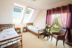 Ένα ή περισσότερα κρεβάτια σε δωμάτιο στο Hotel Wartosław