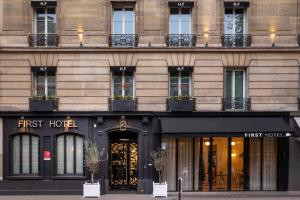 a store front of a building with first hotel at First Hotel Paris Tour Eiffel in Paris