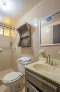 a bathroom with a toilet, sink, and bathtub at Posada del MAR in Ensenada